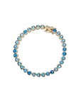Gold tennis bracelet features heart shaped CZ stones in varying shades of blue