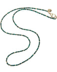 Beaded necklace featuring malachite beads and flat gold beads.