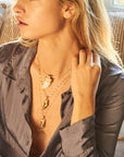 Model wearing various tusk pendants