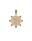 Gold coin pendant with snake design and the french phrase "Gardez bien" with smoky topaz accents on the border and emerald stones on the bail