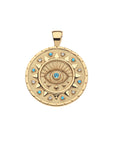 Gold coin pendant with eye design accented with blue topaz and aquamarine stones