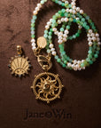 Stylized shot of chrysoprase & pearl double wrap, strong flaring sun cutout coin, and strong petite embellished coin