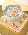 Stylized shot features protect evil eye bracelet and protect eye on you ring