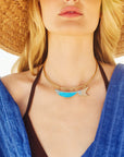 Model wearing the keep swimming fish in turquoise on the neck cuff