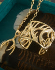Stylized shot of the protect guardian antler pendant on the across all time chain, as well as the protect guardian antler cuff
