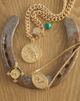 Stylized shot of the petite curb chain, courage year of the horse original, courage horse petite embellished, and courage year of the horse bracelet.