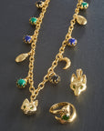 Stylized shot of the protect double wrap charm necklace, protect fox head pendant, and the protect fox ring