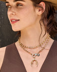Model wearing the across all time double wrapped chain with the protect guardian antler pendant