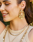 Model wearing the love amore coin drop earrings