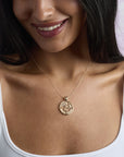 Model wearing the protect cutout coin pendant on a delicate chain