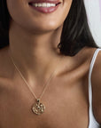 Model wearing Grace cutout coin pendant on a delicate chain