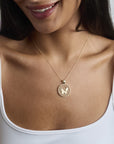 Model wearing Free cutout coin pendant on a delicate chain