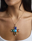 Model wearing the protect gardez bien pyramid pendant on the drawn link chain