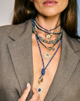 Model wearing various beaded necklaces and star pendants