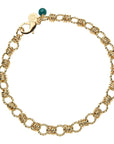 chunky gold chain featuring twisted links, oversized lobster clasp, and malachite bead detail