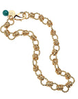 chunky gold chain featuring twisted links, oversized lobster clasp, and malachite bead detail