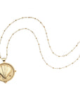Gold clamshell coin on beaded satellite chain
