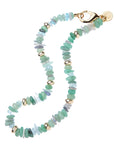 Beaded necklace of Labradorite, Aquamarine, Rut Quartz, Green Strawberry Quartz, and Green Aventurine with gold bead details and oversized gold clasp