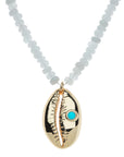 Close up of the cowrie shell pendant on the strong in the waves necklace