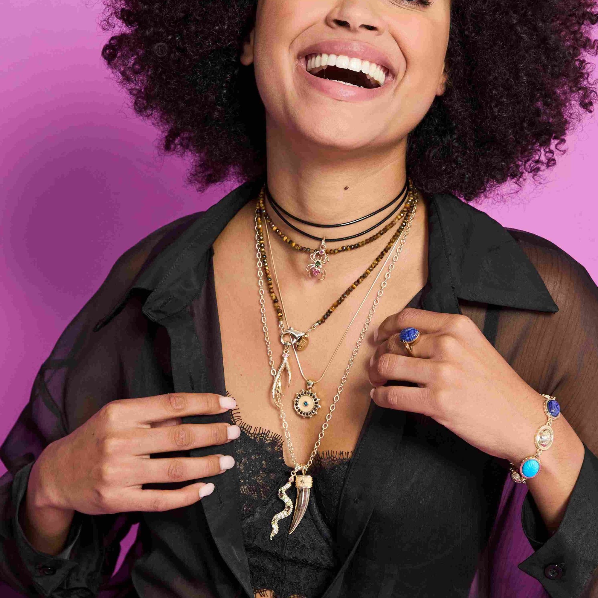 Model wearing assorted pendants and beaded chains