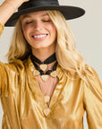 Gold hearts and coins layered on model