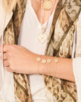 Model wearing each of the baby coin bracelets
