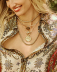 Model wearing assorted bunny pendants and gold chains