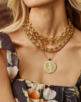 Model wearing the jumbo bonne chance coin with various chunky link necklaces