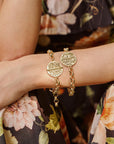 Model wearing 2 bonne chance bracelets to show each side of the coin