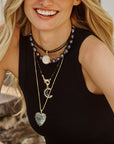 Model wearing labradorite heart, nightfall moon in onyx, and moon face pendant on various chains