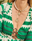 Model wearing starfish cutout pendant and sun pendant