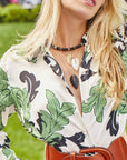 Model wearing assorted feather pendants and obsidian beaded necklace