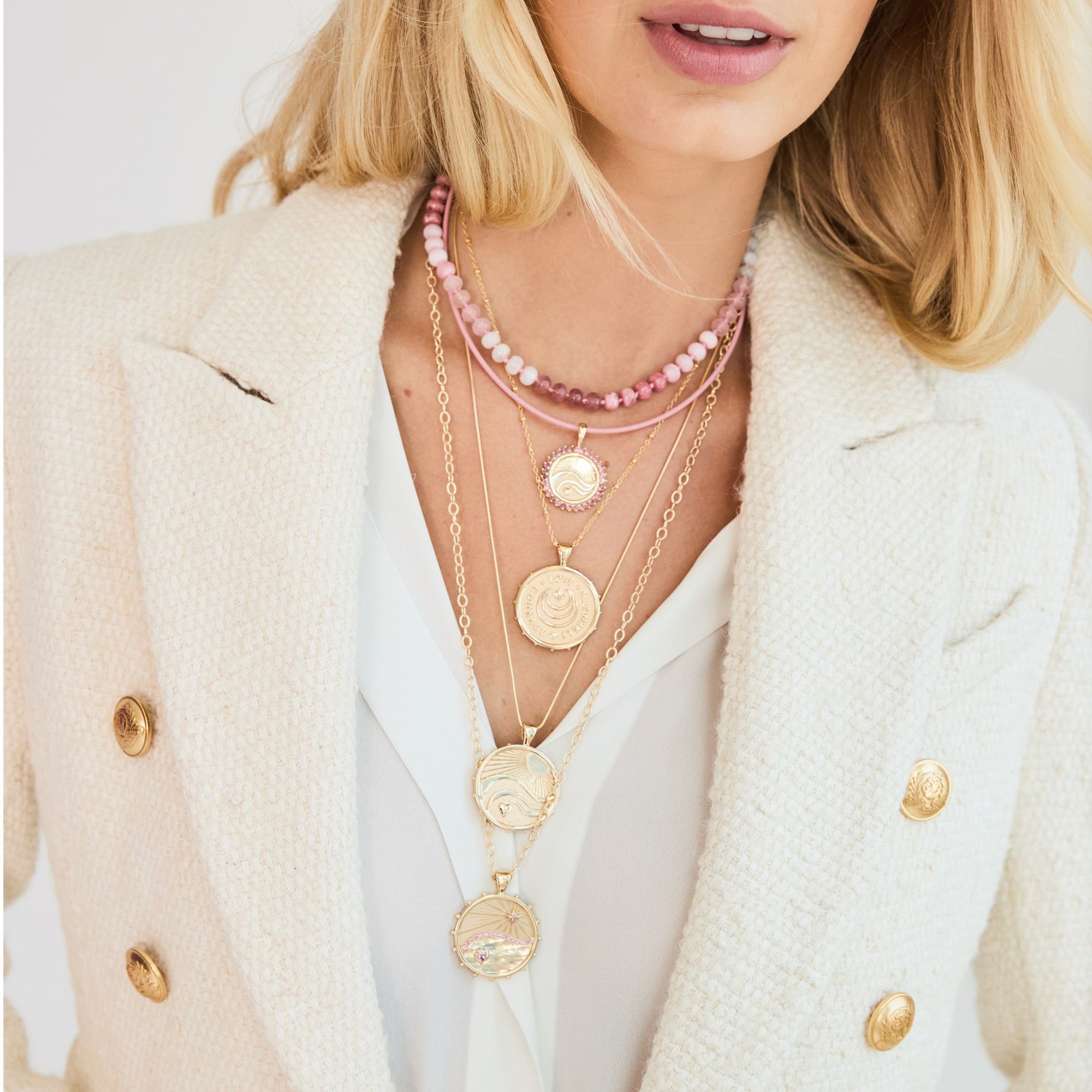 Gold necklaces layered on model