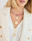 Gold necklaces layered on model