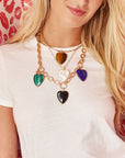 Model wearing multiple carry your heart pendants