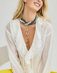 Model wearing layered horseshoe pendants