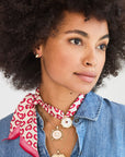 Model wearing gold heart studs