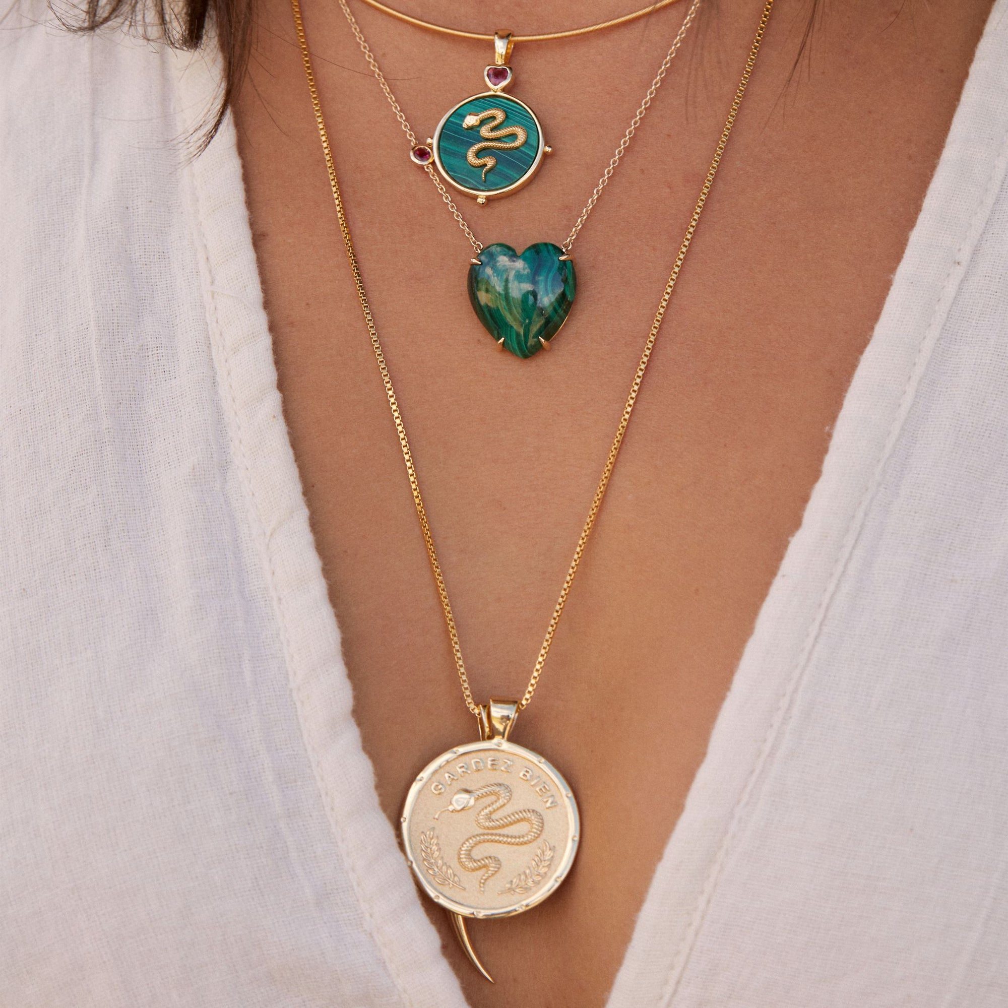 Gold layered necklaces on model