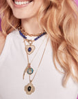 Model wearing layered necklaces
