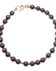 Wood beaded necklace with gold accents and oversized gold lobster clasp