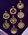 Stylized shot of all cutout coin pendants on dark purple background