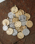 Syled pile of gold and silver coin pendants