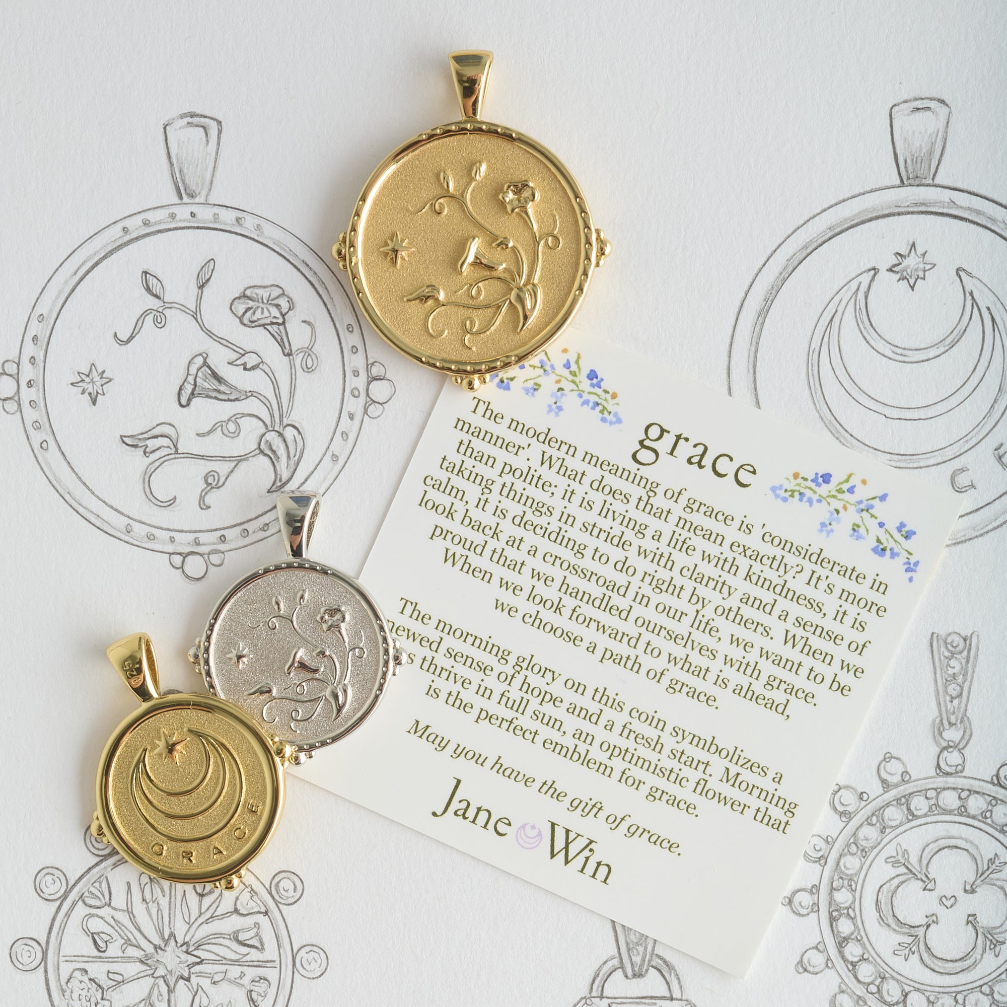 Stylized shot of grace coins with grace card and sketches of the coins
