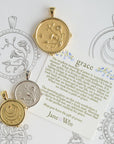 Stylized shot of grace coins with grace card and sketches of the coins