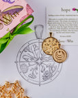 Stylized laydown image of two gold coin pendants with sketch of design