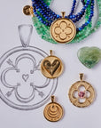 Stylized laydown image of four gold coin pendants with sketch of design
