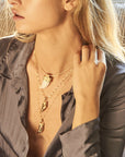 Model wearing various tusk pendants