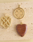Stylized shot of love coin, love in a knot heart, and carved wood heart
