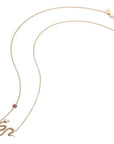 Gold snake pendant with pink tourmaline accent on chain