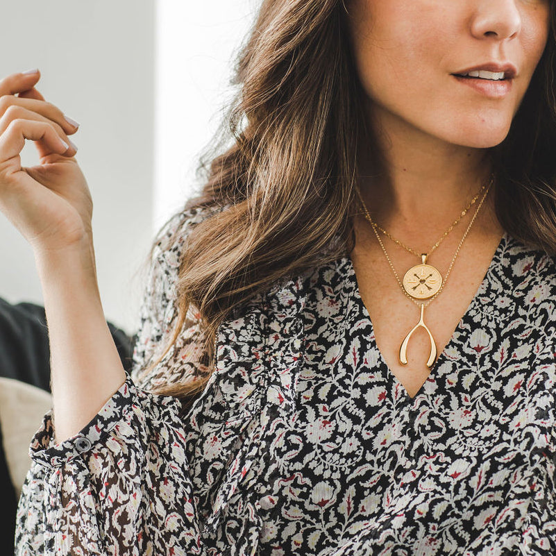 Gold wishbone necklace on model